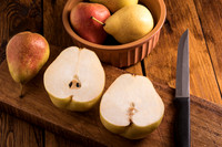 Pears sliced on a wooden board