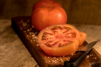 Sliced tomato on a wooden board