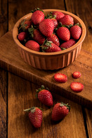 sweet fresh strawberries in a bowl on wood